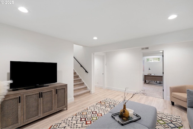 living area featuring stairs, recessed lighting, visible vents, and light wood-style floors