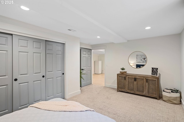 bedroom featuring a closet, recessed lighting, visible vents, and light colored carpet