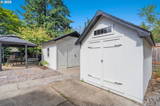 view of shed featuring a gazebo and fence