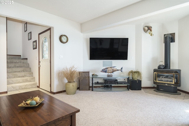 105 NW 45th St Unit 4, Newport, OR 97365 - living room with stairway, a wood stove, and baseboards