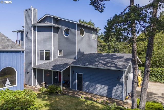 105 NW 45th St Unit 4, Newport, OR 97365 - view of front of house featuring a chimney