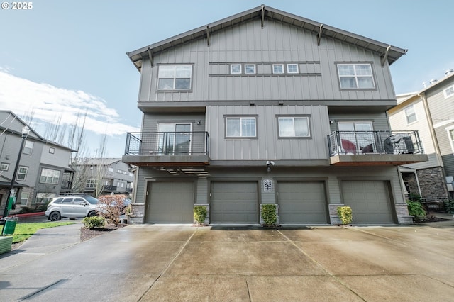 view of front facade featuring driveway, board and batten siding, and an attached garage