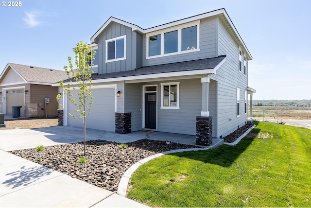 craftsman inspired home featuring a garage, stone siding, a front yard, board and batten siding, and concrete driveway