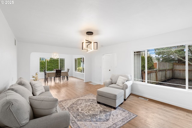 13332 SE Harold St, Portland, OR 97236 - living room with arched walkways, wood finished floors, and baseboards