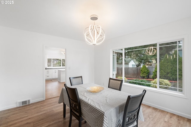 13332 SE Harold St, Portland, OR 97236 - dining area with a chandelier, wood finished floors, and baseboards