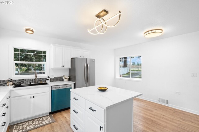 13332 SE Harold St, Portland, OR 97236 - kitchen with dishwasher, freestanding refrigerator, a sink, and plenty of natural light