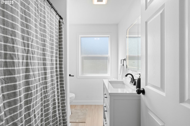 13332 SE Harold St, Portland, OR 97236 - full bath featuring wood finished floors, vanity, toilet, baseboards, and curtained shower