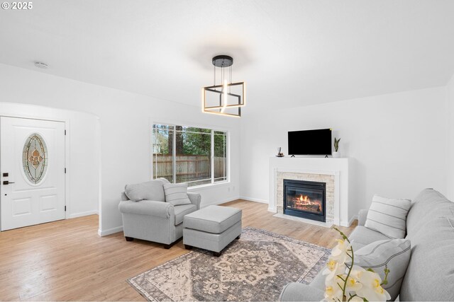 13332 SE Harold St, Portland, OR 97236 - living room featuring light wood-type flooring, a fireplace, and baseboards
