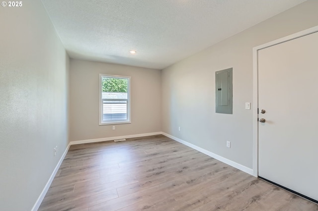 4106 SE 122nd Ave, Portland, OR 97236 - empty room featuring electric panel, wood finished floors, a textured ceiling, and recessed lighting