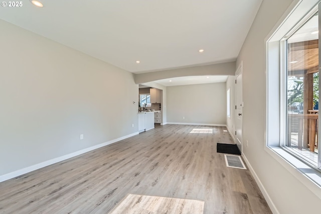 4106 SE 122nd Ave, Portland, OR 97236 - unfurnished living room with light wood-type flooring, recessed lighting, and arched walkways