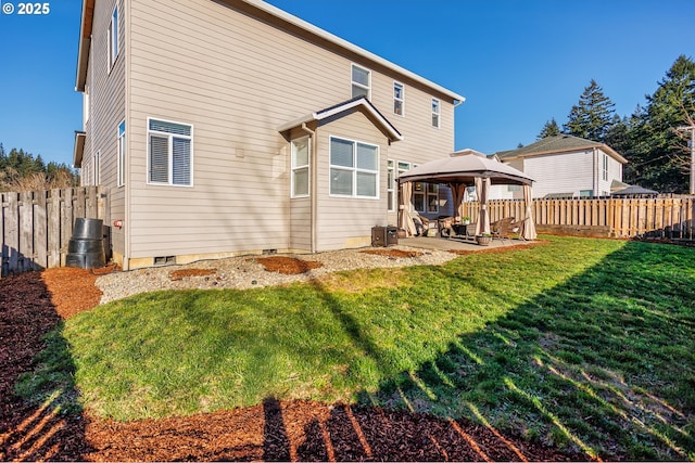 back of house with a gazebo, a lawn, and a patio