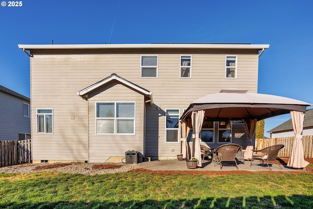 back of house featuring a gazebo, a yard, and a patio