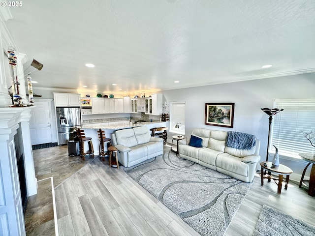 842 Chetco Point Ter, Brookings, OR 97415 - living room with crown molding, light wood-style floors, recessed lighting, and a fireplace