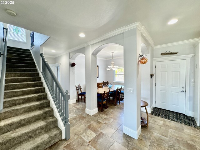 842 Chetco Point Ter, Brookings, OR 97415 - entryway with stairs, stone tile floors, arched walkways, ornamental molding, and recessed lighting