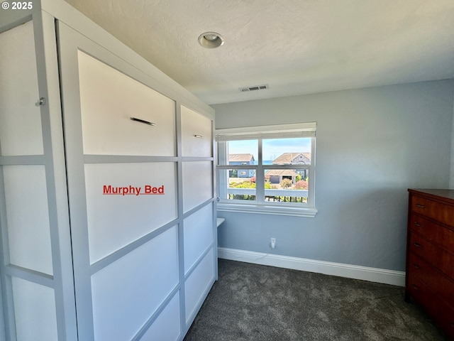 842 Chetco Point Ter, Brookings, OR 97415 - unfurnished bedroom with dark colored carpet and a textured ceiling