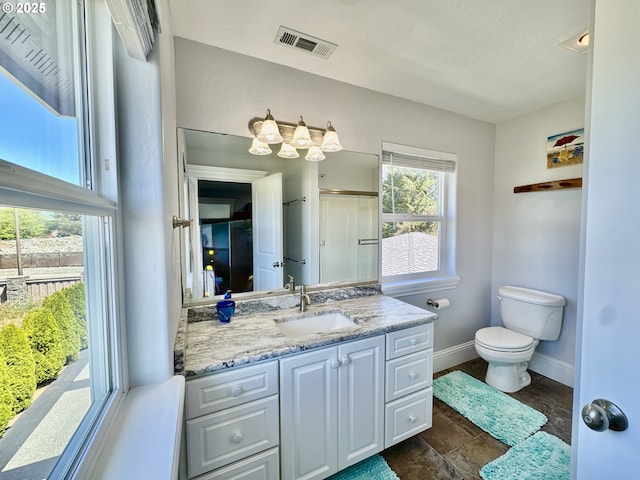 842 Chetco Point Ter, Brookings, OR 97415 - bathroom with vanity, stone finish floors, and a shower with shower door