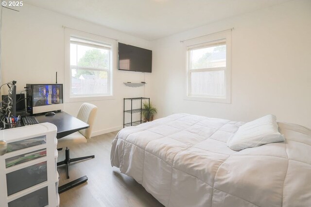 249 27th Ave, Longview, WA 98632 - bedroom with wood finished floors, multiple windows, and baseboards