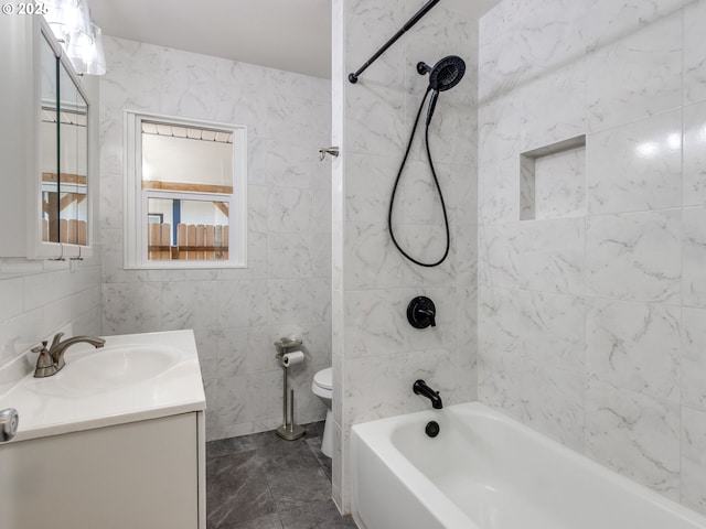 full bath featuring toilet,  shower combination, vanity, and tile walls