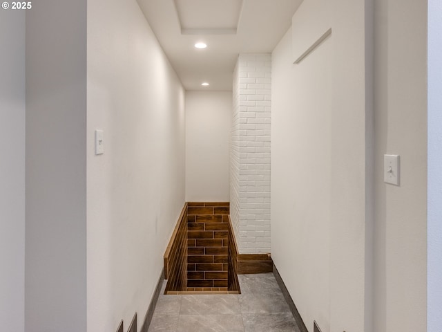 hall with recessed lighting and baseboards
