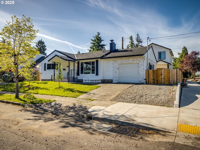 view of front facade with a garage, concrete driveway, a chimney, and stone siding