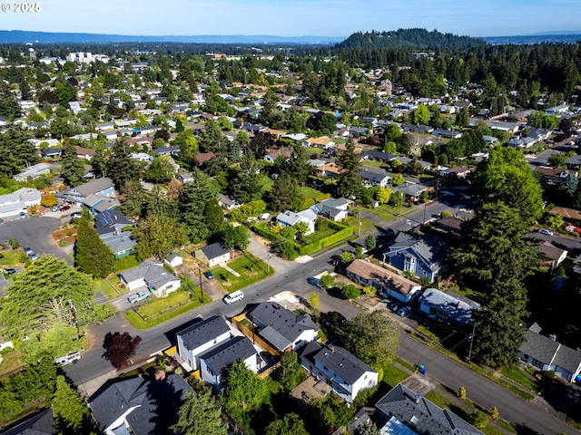 aerial view of property and surrounding area featuring nearby suburban area