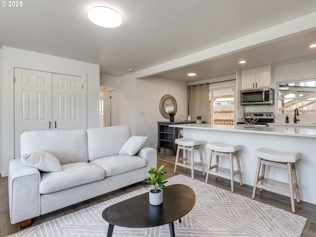 living room with recessed lighting and wood finished floors