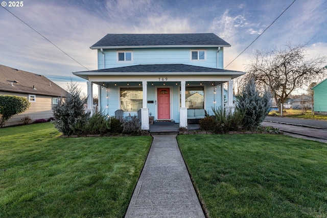 bungalow-style home featuring a porch and a yard