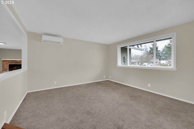 empty room with carpet floors, a wall mounted AC, and a fireplace