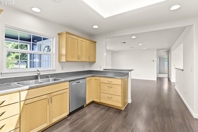 kitchen with dishwasher, a sink, light brown cabinets, a peninsula, and dark countertops