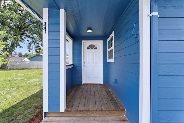 entrance to property featuring a lawn