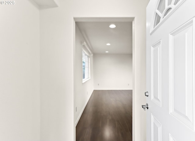 hall featuring recessed lighting, baseboards, and wood finished floors