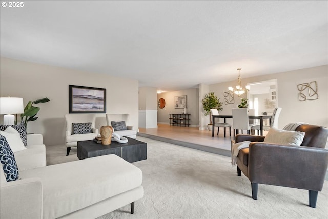 living area featuring an inviting chandelier and light carpet