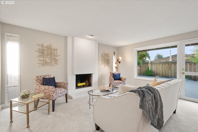 living area featuring a brick fireplace and light carpet
