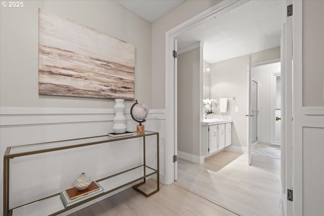 bathroom featuring a stall shower, wood finished floors, and vanity