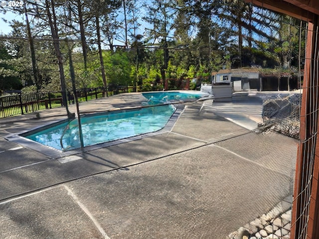 view of pool with a patio, fence, and a fenced in pool