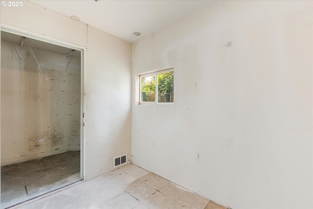 unfurnished bedroom featuring visible vents
