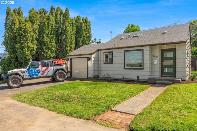 view of front facade with an attached garage, driveway, roof with shingles, and a front lawn