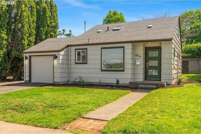 view of front of property with a shingled roof, an attached garage, and a front yard