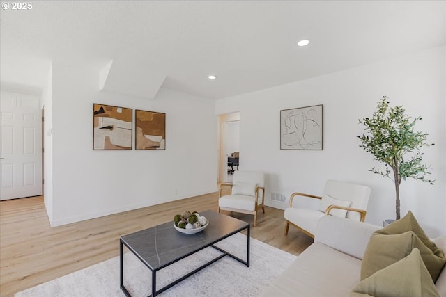 living area with visible vents, recessed lighting, baseboards, and wood finished floors