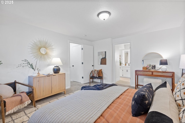 carpeted bedroom featuring ensuite bathroom