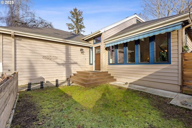 property entrance featuring a lawn