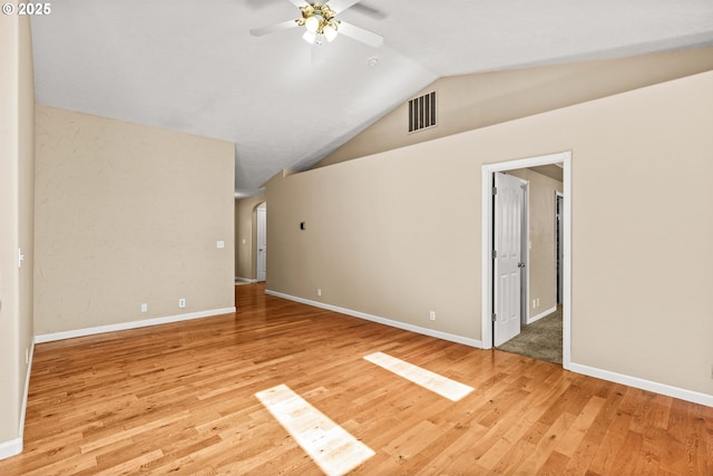 3473 Parker Ln, Springfield, OR 97477 - empty room with a ceiling fan, vaulted ceiling, light wood-style floors, baseboards, and arched walkways