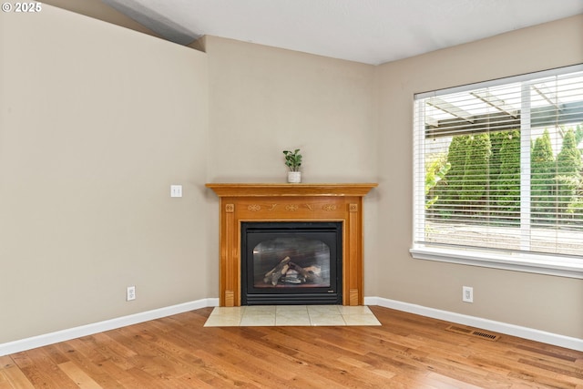 3473 Parker Ln, Springfield, OR 97477 - detailed view of wood finished floors, a fireplace with flush hearth, and baseboards