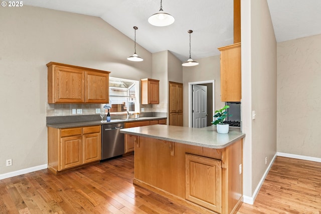 3473 Parker Ln, Springfield, OR 97477 - kitchen featuring dishwasher, light wood-type flooring, a peninsula, hanging light fixtures, and tasteful backsplash
