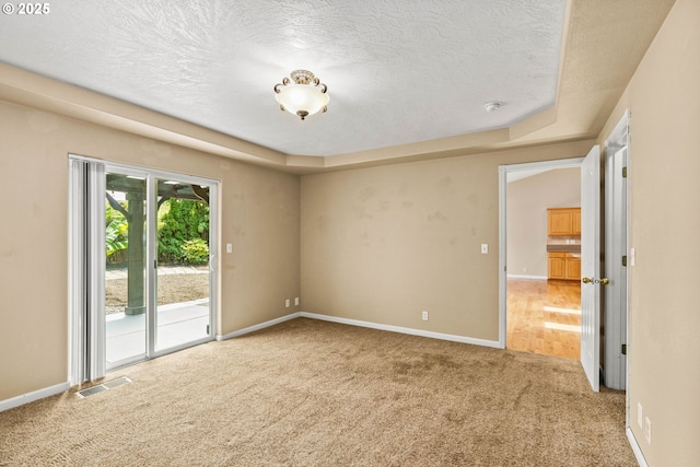 3473 Parker Ln, Springfield, OR 97477 - carpeted empty room with a textured ceiling, baseboards, a smoke detector, and a tray ceiling