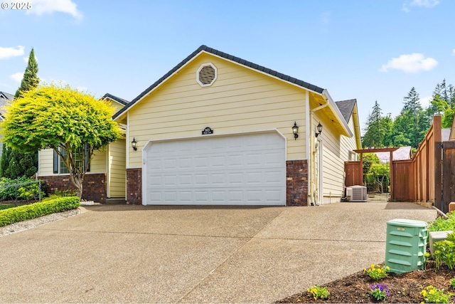 3473 Parker Ln, Springfield, OR 97477 - view of front of home with brick siding, concrete driveway, an attached garage, and central air condition unit