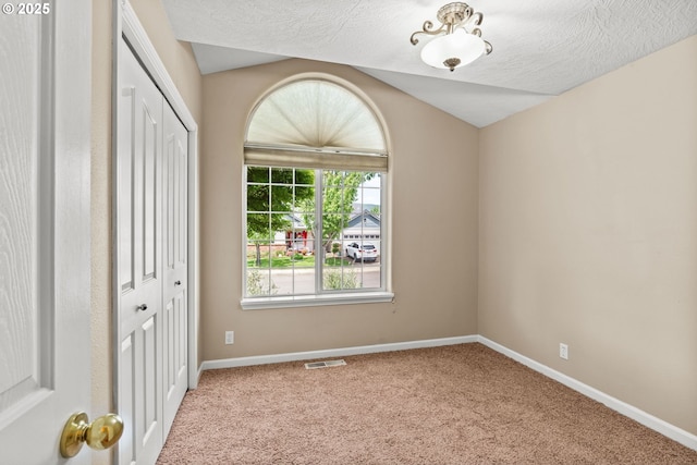 3473 Parker Ln, Springfield, OR 97477 - spare room with carpet flooring, baseboards, a textured ceiling, and lofted ceiling