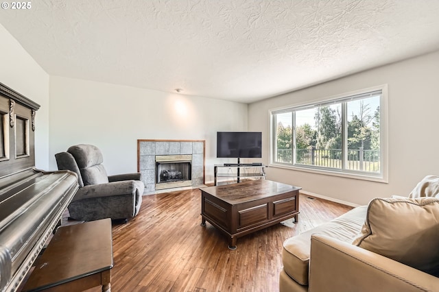22160 NE Lachenview Ln, Fairview, OR 97024 - living room featuring wood finished floors, a tile fireplace, and a textured ceiling