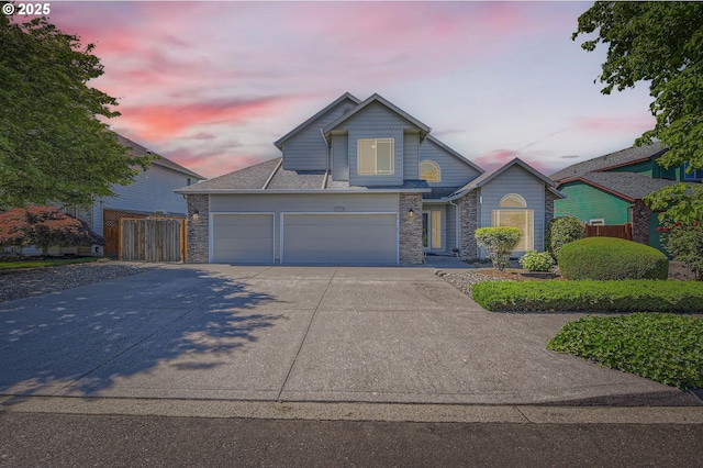 22160 NE Lachenview Ln, Fairview, OR 97024 - view of front of house featuring an attached garage, driveway, and stone siding