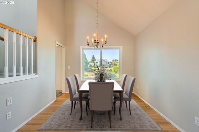 22160 NE Lachenview Ln, Fairview, OR 97024 - dining area with a chandelier, light wood-type flooring, baseboards, and high vaulted ceiling